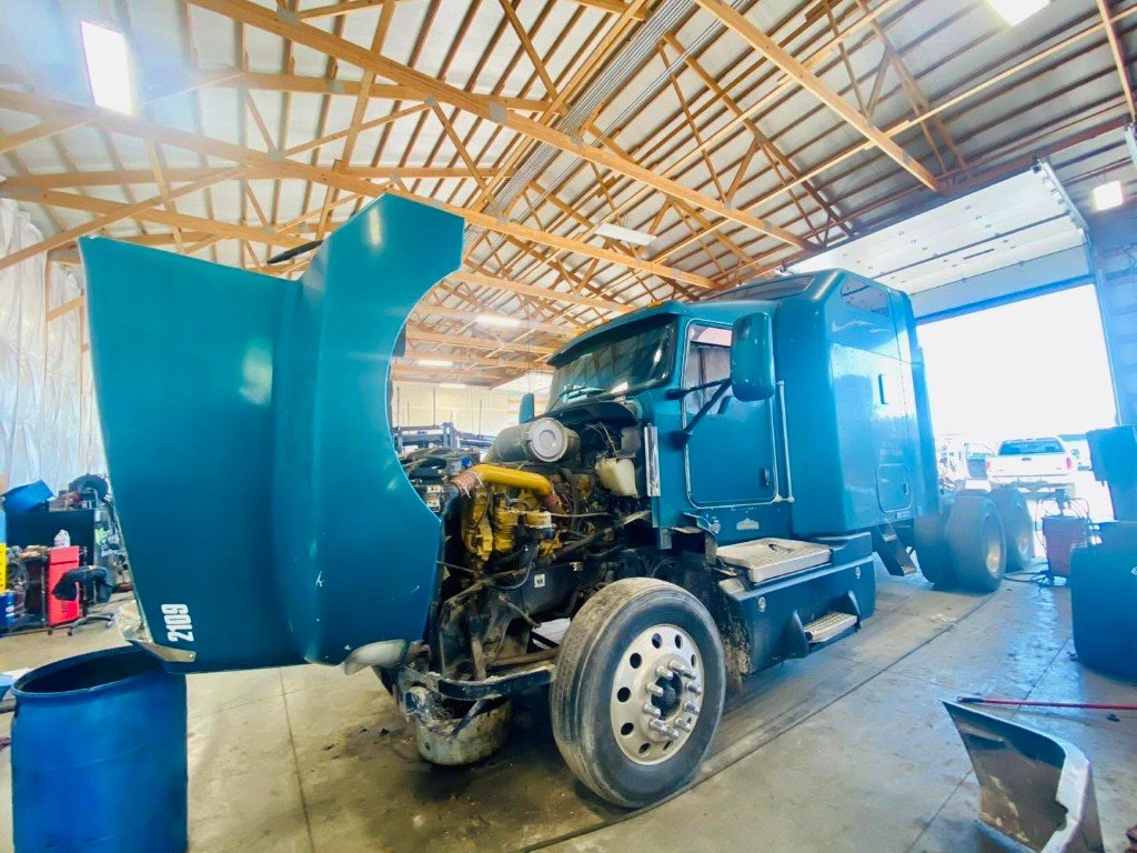 Semi in an open T&E bay with the engine exposed
